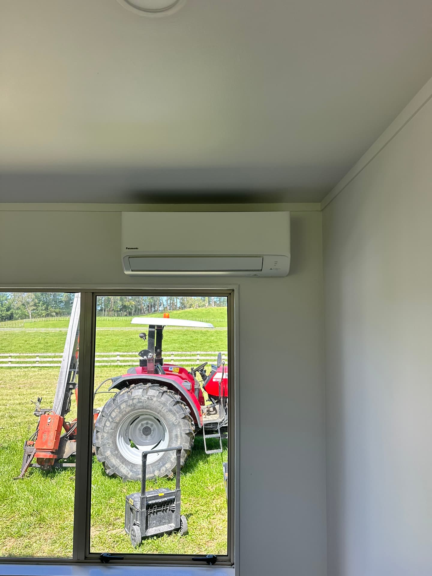 Wall-mounted heat pump installed above a window by Climate Systems, providing efficient heating and air conditioning for a Waikato property.
